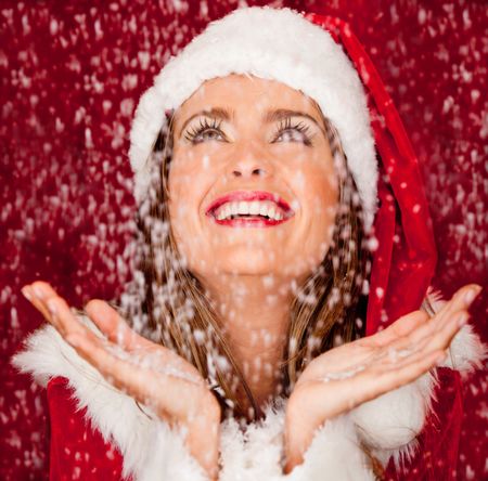 Woman with Santa outfit in a snowy Christmas