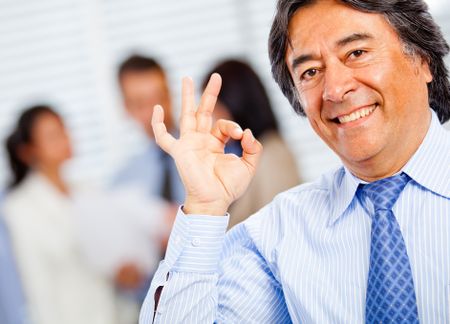 Successful business man making an ok sign with his hand