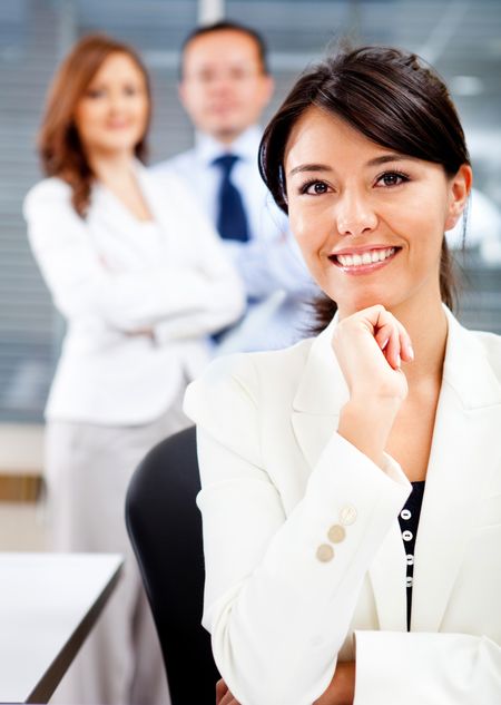 Successful woman with a business team looking confident
