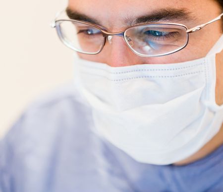 Portrait of a male dentist wearing a facemask