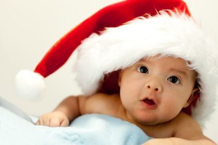 Cute baby with Santa hat on his first Christmas