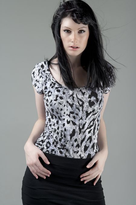young-woman-black-skirt-animal-print-90235381 Young woman in a black skirt and animal print top