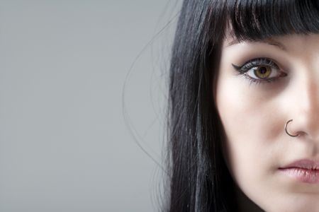 Close up of young woman's face with black hair
