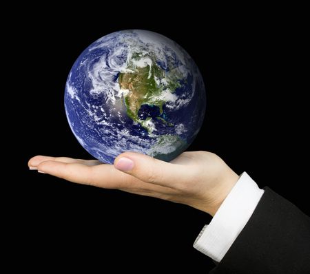 business hand holding globe over a black background