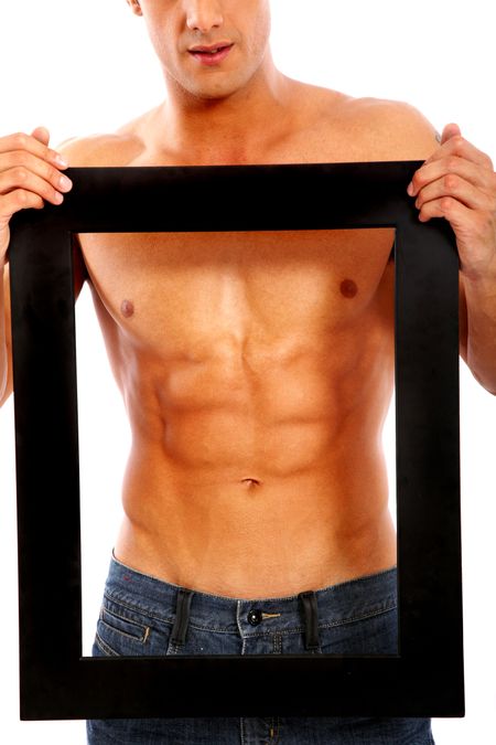 strong muscular man framing his abdominal muscles and chest with a black frame