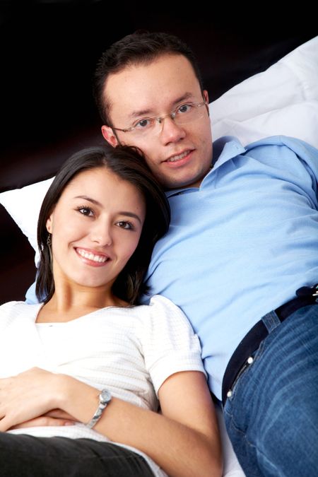 couple relaxing at home on their bed