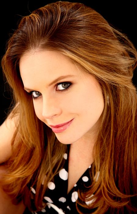 fashion woman portrait in a black dress over a dark background