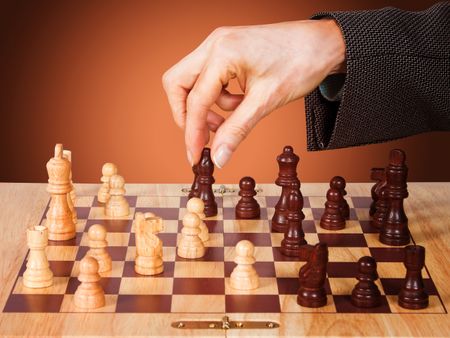 Business female hand moving a chess piece