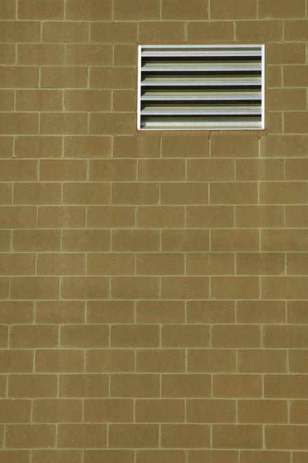 Abstract realism: Vent in exterior brick wall of building