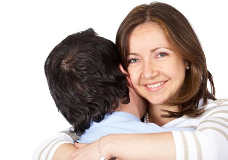 happy young couple hugging isolated over a white background