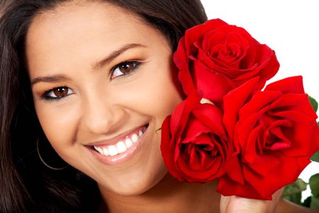 woman holding red roses and smiling isolated over a white background