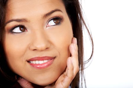 pensive woman smiling isolated over a white background