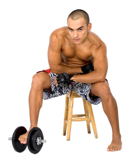 fitness man doing free weights exercises isolated over a black background