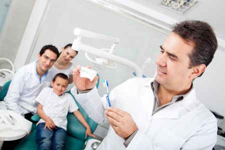 Dentist explaining how to brush teeth on a prosthesis