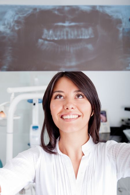 Woman at the dentist holding a dental x-ray