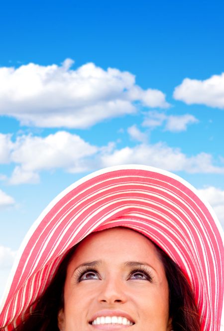 Woman portrait wearing a summery hat on a beautiful day