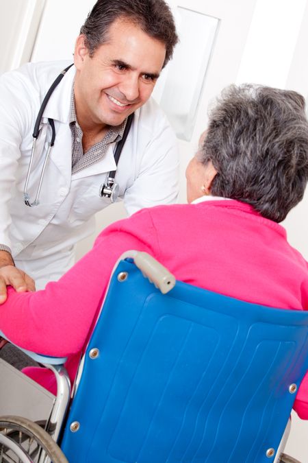 Old woman arriving to the hospital in a wheelchair