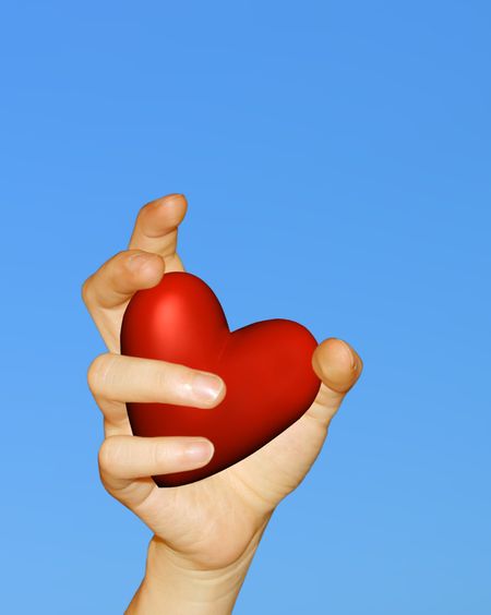 Red Heart on a hand with a blue background