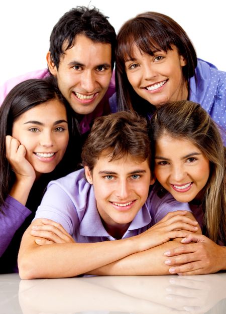 Group of young people smiling and lying on the floor