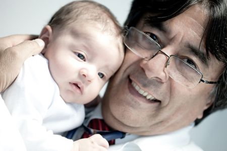 Portrait of a doctor holding a cute baby and smiling