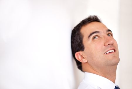 thoughtful-business-man-leaning-wall-looking-92988913 Thoughtful business man leaning on the wall looking up