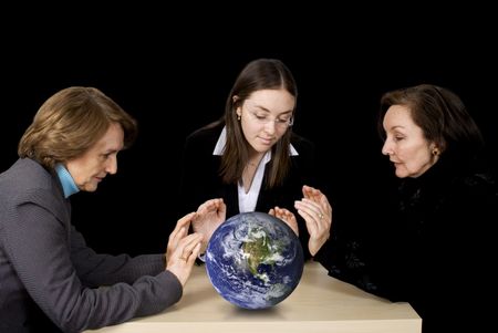 Business female management team with hands over earth globe with a black background