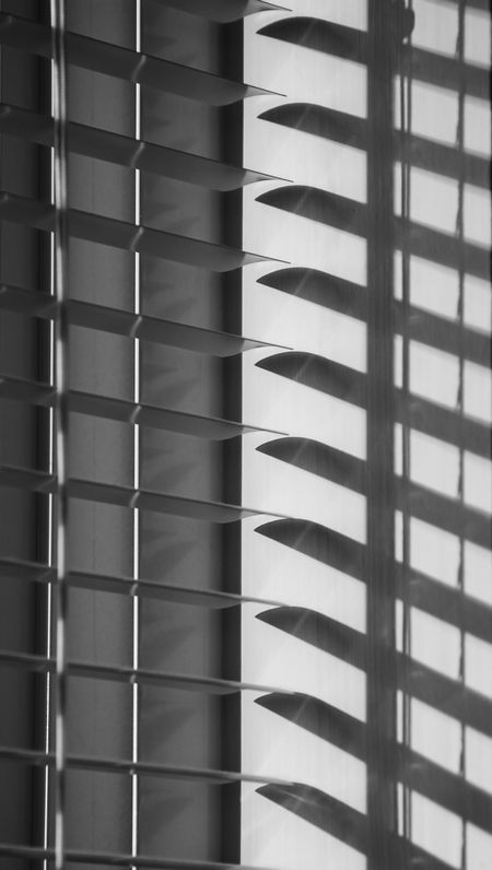 Window blinds and shadows on wall