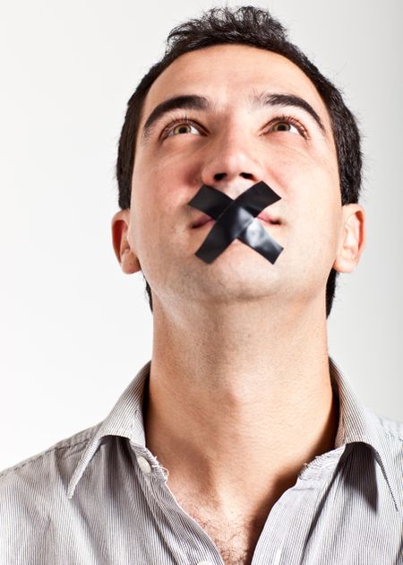 Silenced man with tape on his mouth - isolated over a white background