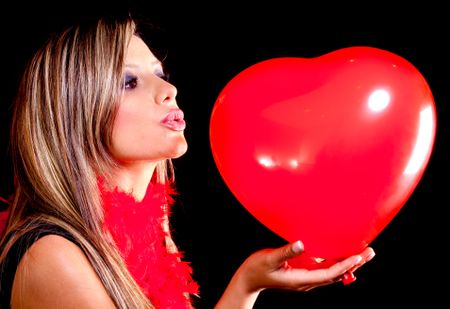 woman-celebrating-valentines-day-kissing-heart-93659116 Woman celebrating Valentines Day kissing a heart shaped balloon