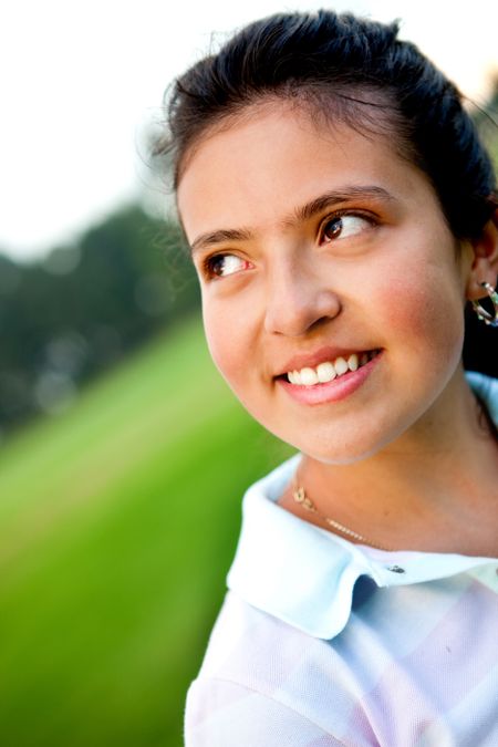 Portrait of a thoughtful girl outdoors smiling