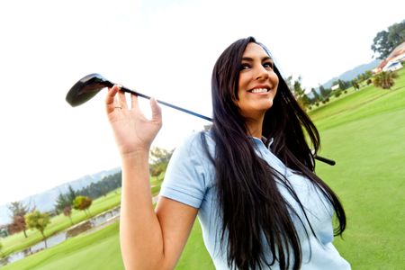 Beautiful woman playing golf at the club