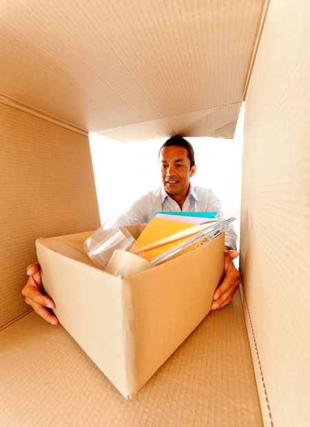 Man packing in cardboard boxes to move house