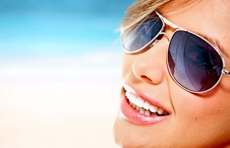 Beautiful woman wearing sunglasses on a summery day
