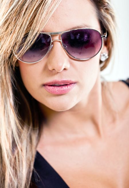 Portrait of a woman with sunglasses - isolated over a white background