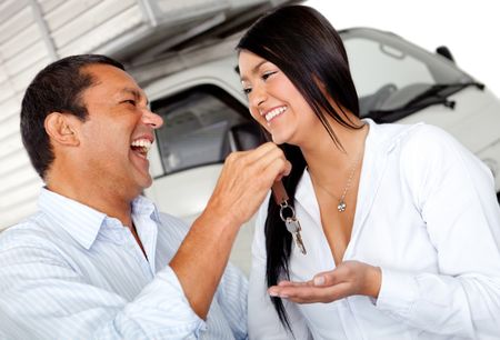 Man giving his wife the keys of the truck - isolated over a white background
