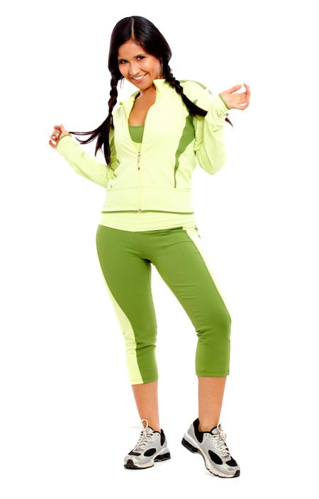 sporty woman looking happy standing up - isolated over a white background