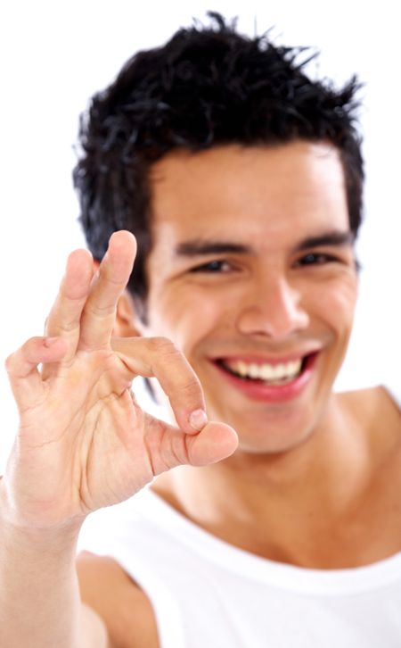 casual man smiling doing the ok or okay sign over a white background
