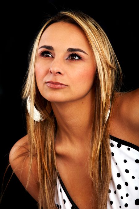 casual woman portrait wearing make up looking up with a pensive face