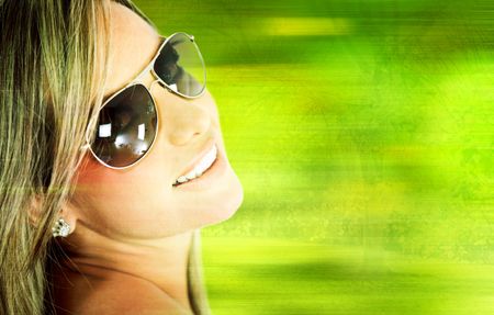 Beautiful woman wearing sunglasses â?? over a green background