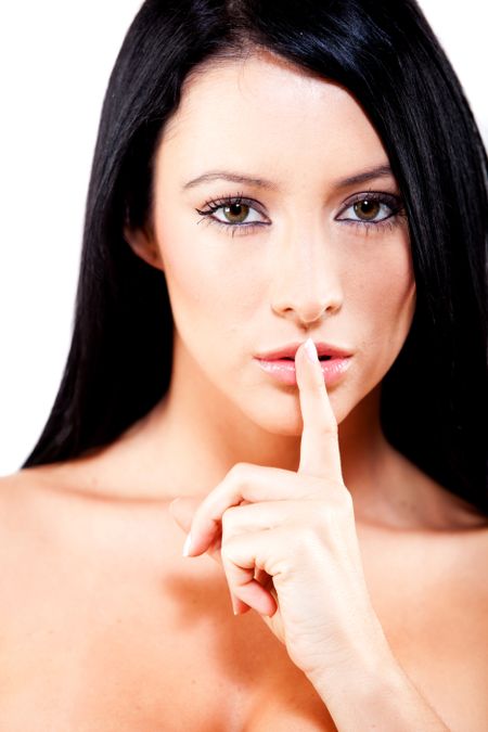 Woman making a keep quiet gesture putting her finger on mouth - isolated