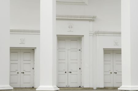 Three sets of tall doors at front of Protestant church