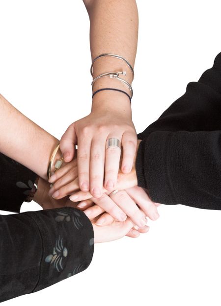 business team with their hands together over white