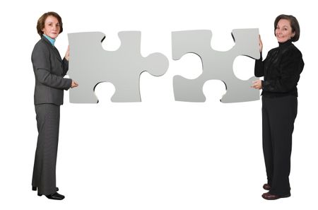 business women holding puzzle pieces