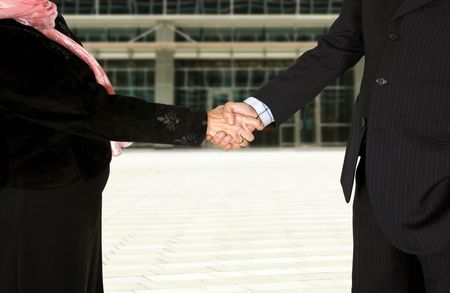 business couple shaking hands over a white background - full bodies