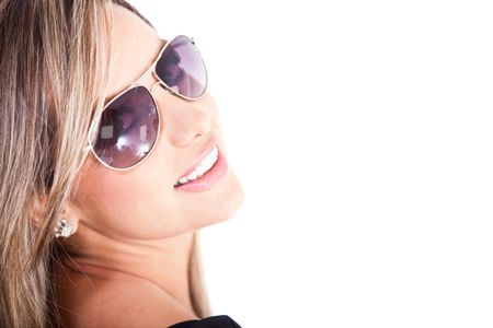 Beautiful woman wearing sunglasses and smiling - isolated over a white background