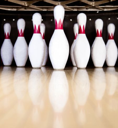 Ten white pins in a bowling alley