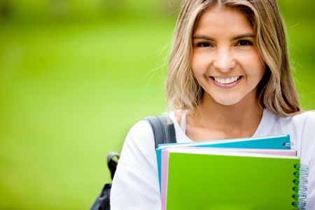 Portrait of a happy female student smiling outdoors