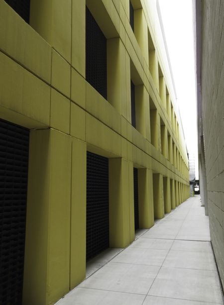 Urban perspective: Sidewalk between parking garage and building