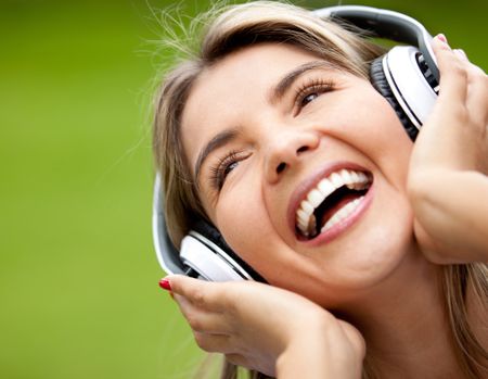 Happy woman portrait with headphones listening to music