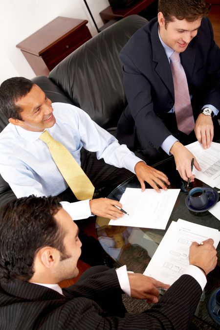 businessmen in a business meeting in an office smiling